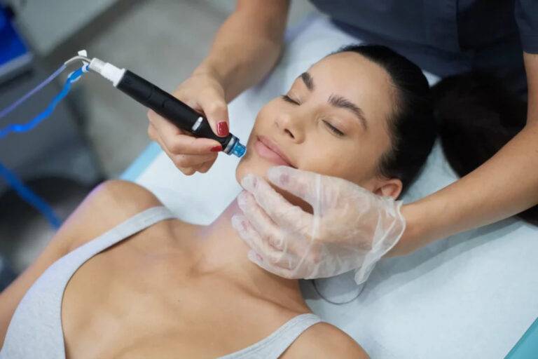 Femme réalisant une soin hydrafacial fait par une esthéticienne